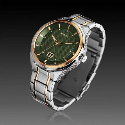 a watch with a green dial on a silver bracelet