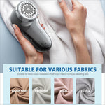 Gray and silver fabric shaver electric with 6-leaf blades and perforated circular head for clothing and furniture use