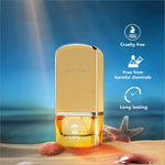 a bottle of perfume sitting on top of a sandy beach