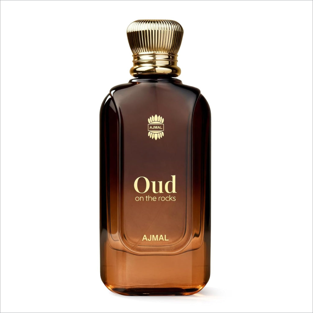 A sleek amber glass bottle of ajmal oud on the rocks eau de parfum with gold cap and smoky oud woody amber notes