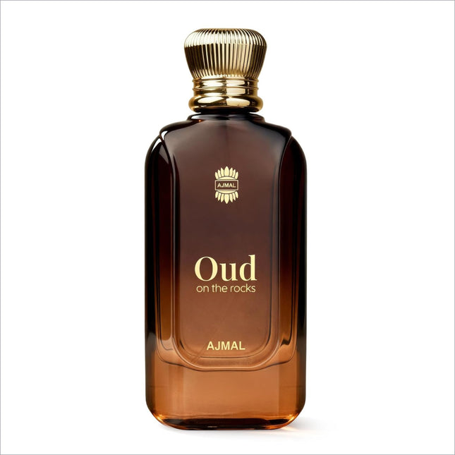 A sleek amber glass bottle of ajmal oud on the rocks eau de parfum with gold cap and smoky oud woody amber notes