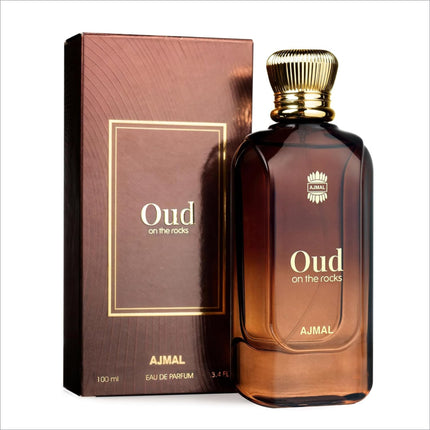 A rich amber glass bottle of ajmal oud on the rocks eau de parfum with gold-toned ribbed cap smoky oud fragrance