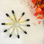 An arrangement of colorful perfume vials from the Armaf Discovery Set - Premium Luxury Fragrance (7ML x 24 PCS) Long-Lasting Fragrance for Men & Women, highlighting the travel perfume set's variety. Managed by Armaf, this new collection makes an excellent choice for fragrance enthusiasts.