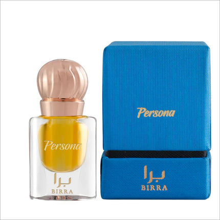 Clear glass perfume bottle with vibrant yellow liquid, accompanied by a blue box, showcasing the 'Persona' brand in gold lettering on both the bottle and the box.