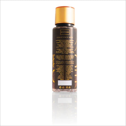 Back view of the Bewitched Body Mist bottle by BIRRA, showcasing the ingredient list and product information, with a black and gold aesthetic.