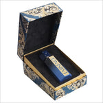 Open box revealing the BIRRA Eminence Premium Perfume, featuring a beautifully designed dark blue bottle nestled in soft black cushioning, emphasizing luxury.
