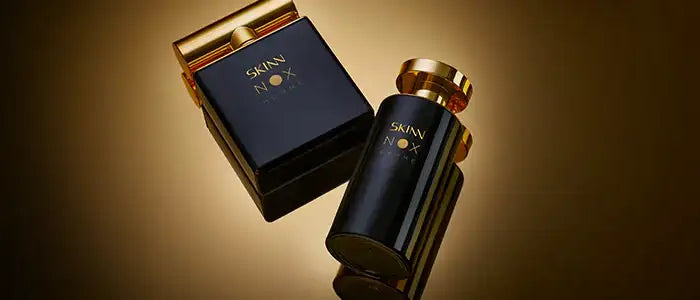 Black skin79 perfume bottle with gold-toned cap and matching box, sleek design.