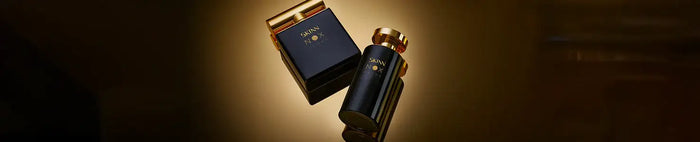 Black skin79 perfume bottle with gold-toned cap and matching box, sleek design.