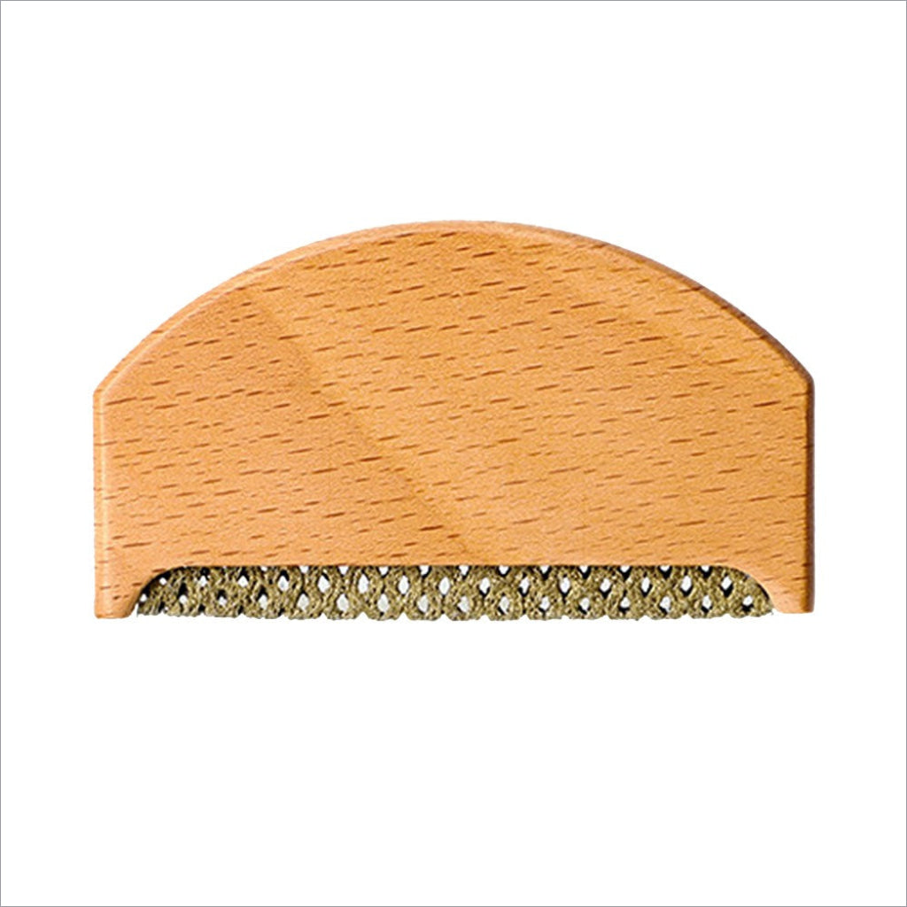 Light-colored wooden clothes fabric shaver with woven metal comb edge for fabric shaver lint removal on wool sweaters