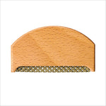 Light-colored wooden clothes fabric shaver with woven metal comb edge for fabric shaver lint removal on wool sweaters
