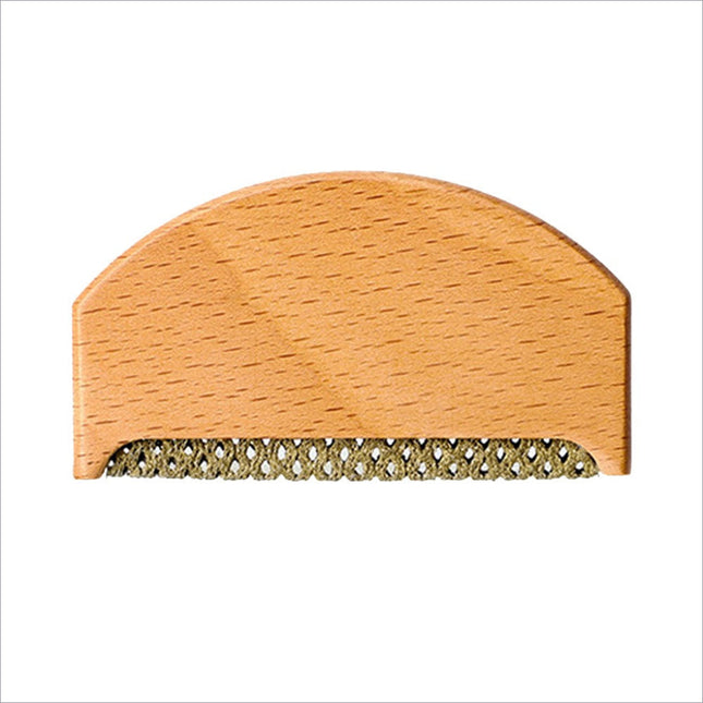 Light-colored wooden clothes fabric shaver with woven metal comb edge for fabric shaver lint removal on wool sweaters