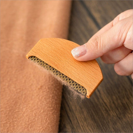 Light brown wooden clothes fabric shaver with honeycomb rubber surface for fabric shaver lint removal on wool sweaters