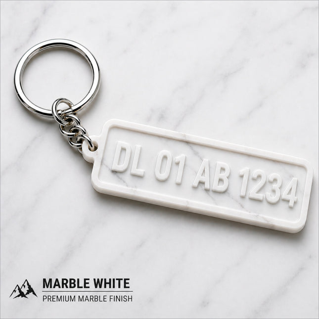 White marble-finish custom number plate keychain with embossed dl 01 ab 1234 design for car enthusiasts