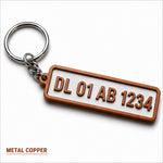 Copper-colored metal custom number plate keychain with raised lettering for personalized car enthusiast accessories