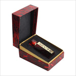 Open box of MAGNATE Premium Perfume by BIRRA, highlighting the luxury presentation with a small red bottle placed on a plush black interior.