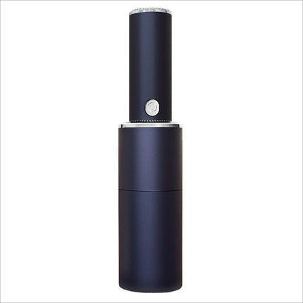 Black cylindrical mini vacuum cleaner with silver accents and circular button featuring strong suction for home office car cleaning