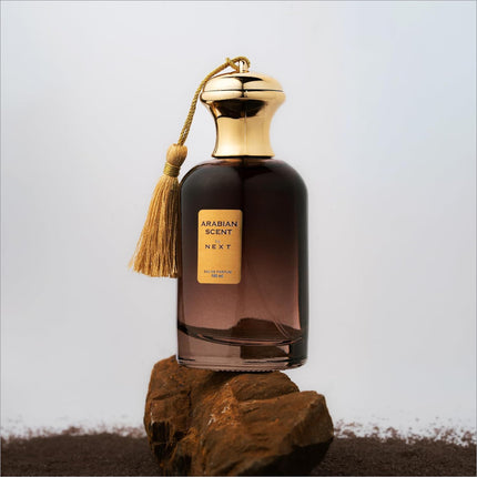Next arabian scent eau de perfume in a dark amber glass bottle with gold cap and tassel for perfume and skin care