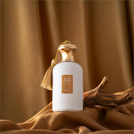 White perfume bottle with gold cap and tassel labeled gold scent next eau de perfume for skin care use