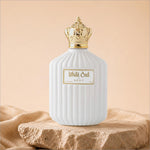 White oud perfume in a white ceramic bottle with gold crown cap and ribbed texture for skin care use