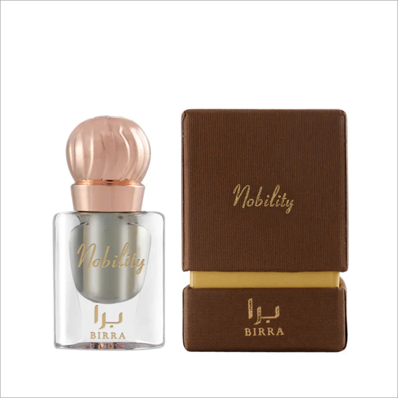 Nobility 6ML attar by BIRRA in a clear glass bottle with a rose gold cap, presented alongside its elegant brown packaging featuring gold lettering.