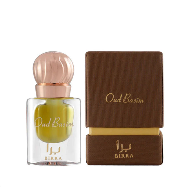 Oud Basim perfume bottle by BIRRA sits next to its elegant packaging, featuring a stylish round cap and gold accents, ideal for fragrance enthusiasts.
