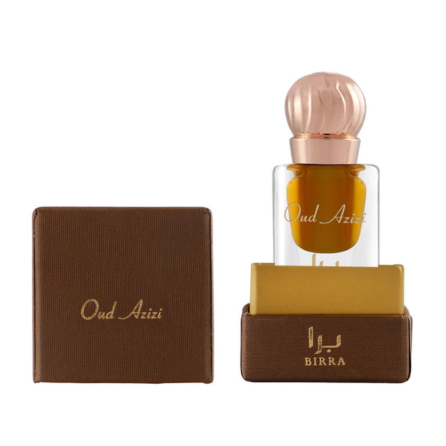 Close-up of Oud Azizi attar bottle showcasing its elegant design with a rose gold cap, resting on a brown box inscribed with the brand BIRRA.