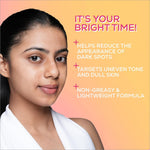 A woman with dark hair wearing a white top against an orange gradient background with renee everyday face bright serum