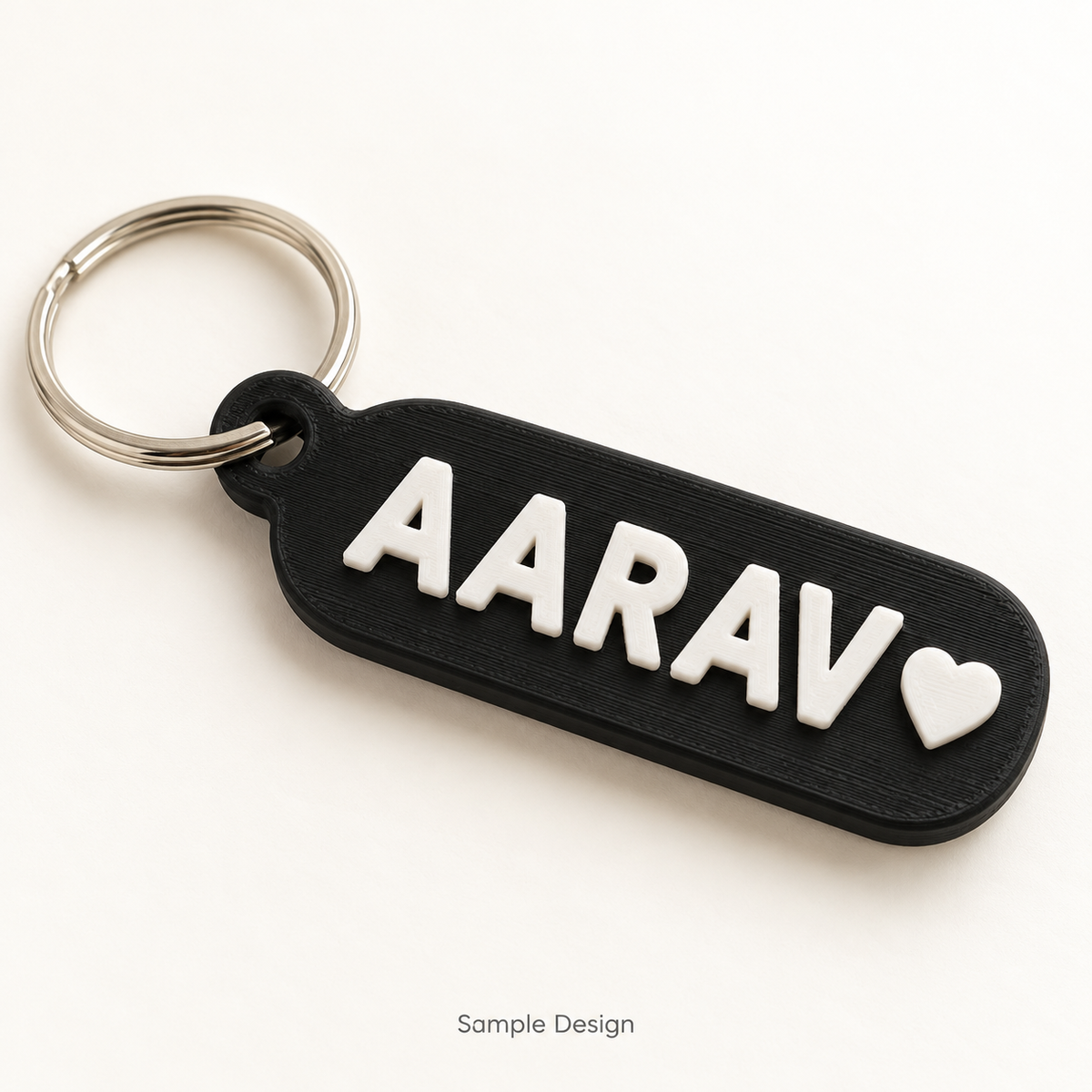 Rubnic sample black 3D printed personalized name keychain with white raised letters and heart