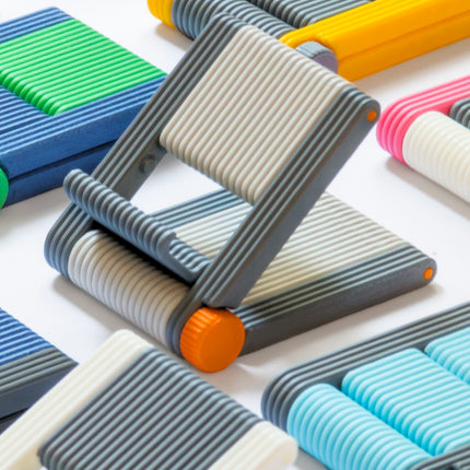 Foldable 3D printed phone stands in multiple colours