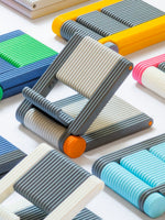 Foldable 3D printed phone stands in multiple colours