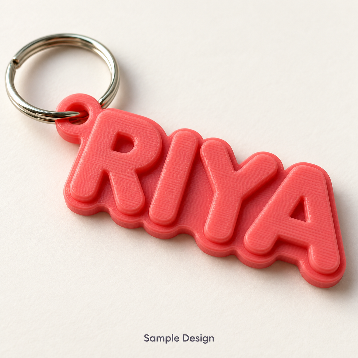 Rubnic sample coral connected-letter 3D printed name keychain spelling RIYA