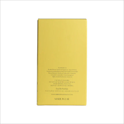 The back view of Sheen premium perfume packaging, detailing the ingredient list and warnings, presented on a yellow box.