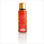Back view of the Simply Ecstatic Body Mist bottle displaying ingredient details and product information. The design continues the floral theme, maintaining a colorful aesthetic with a golden cap.