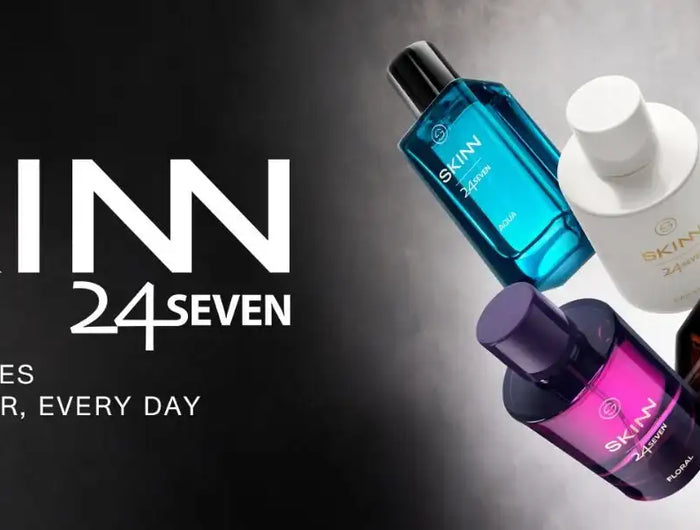 The skinn 24/7 collection features sleek, modern perfume bottles in vibrant translucent colors like blue, white, amber, and purple with minimalist black caps.