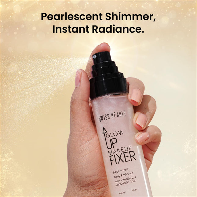 A translucent pink bottle of Swiss Beauty Glow Up makeup fixer with black spray nozzle and dewy radiance formula label