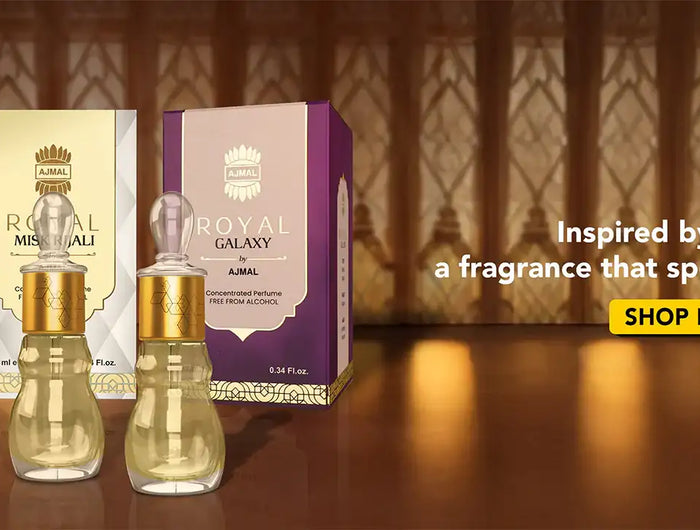 Three elegant glass perfume bottles with gold caps, each paired with a distinctively colored box—brown for royal oud kuwaiti, cream for royal misk alau, and purple for royal galaxy.