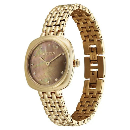 a gold watch with a mother of pearl dial