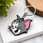 Gray tom face keychain from tom and jerry with pink inner ears black outline and silver metal ring ideal for perfume or skin care bags