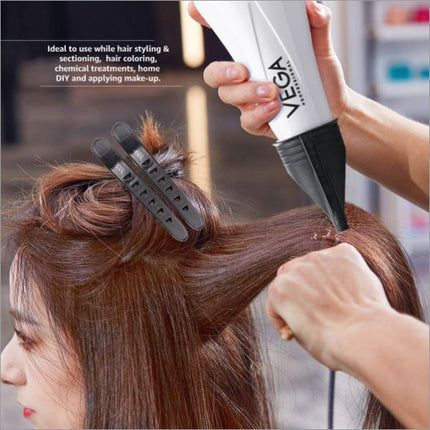 a woman blow drying her hair with a hair dryer