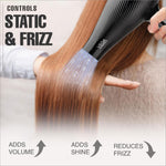 a woman using a hair dryer on her long hair