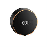 Black circular soap dispenser smart with gold trim displaying battery level and temperature for touchless use