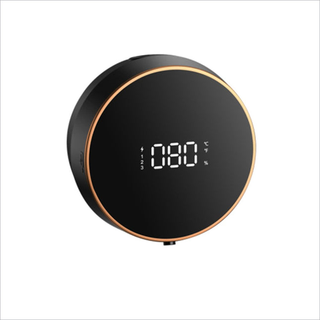 Black circular soap dispenser smart with gold trim displaying battery level and temperature for touchless use