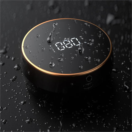 Black circular digital clock soap dispenser smart with gold rim and water droplets on glossy surface for home office use