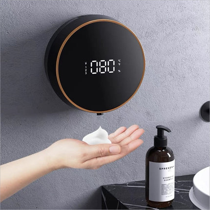 Black circular wall-mounted soap dispenser smart touchless with gold trim and digital temperature and battery display