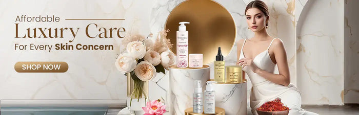 White marble pedestal holding assorted luxury skincare products in gold, silver, and pink packaging