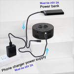 Black circular wireless phone charger with multiple ports and ventilation slots shown with yt200 mini projector for korean skin care use