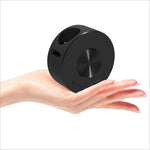 Black cylindrical portable speaker with brushed metal accents next to yt200 usb rechargeable mini projector for korean skin care use